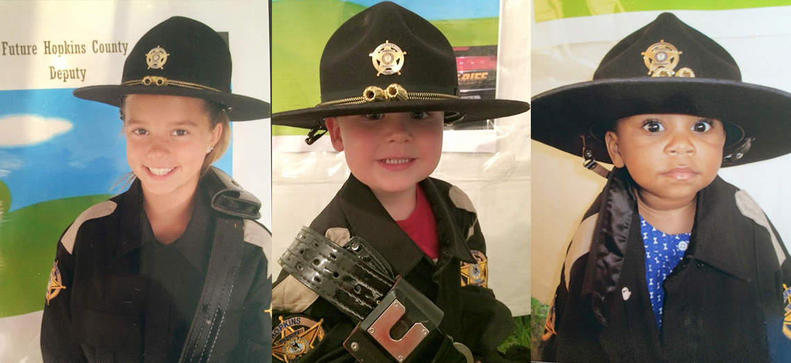 Photo of three children in officer uniform